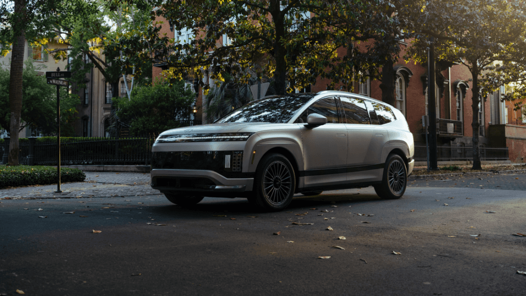 2026 Hyundai IONIQ 9 parked on a city street showcasing its bold front-end design and sleek lighting.