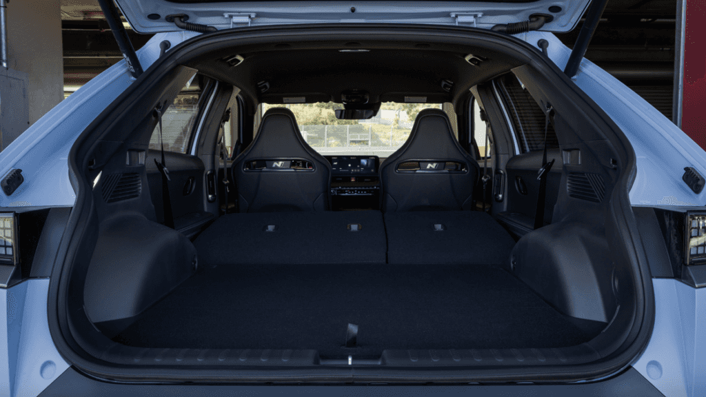 Folded rear seats and sporty front bucket seats inside the 2025 Hyundai IONIQ 5 N hatchback interior.