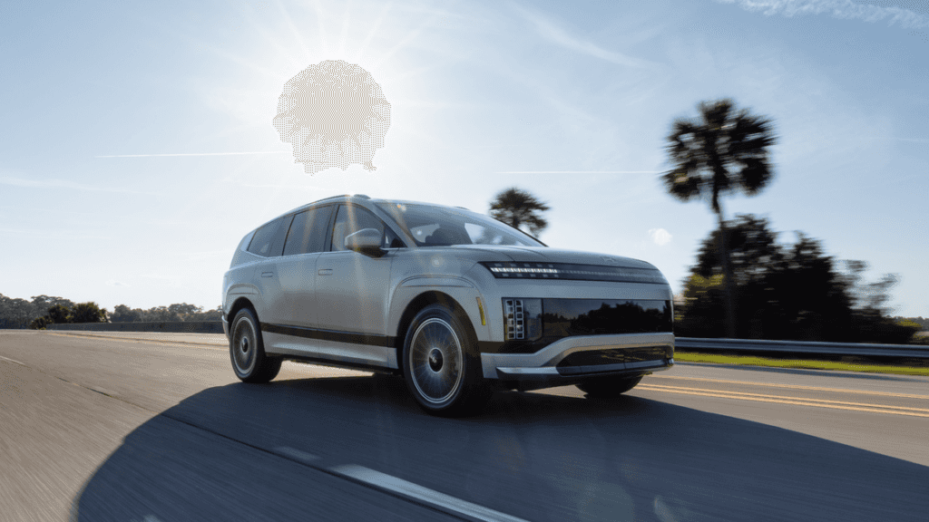 2026 Hyundai IONIQ 9 exterior in silver, front three-quarter view on highway with sleek LED lighting.