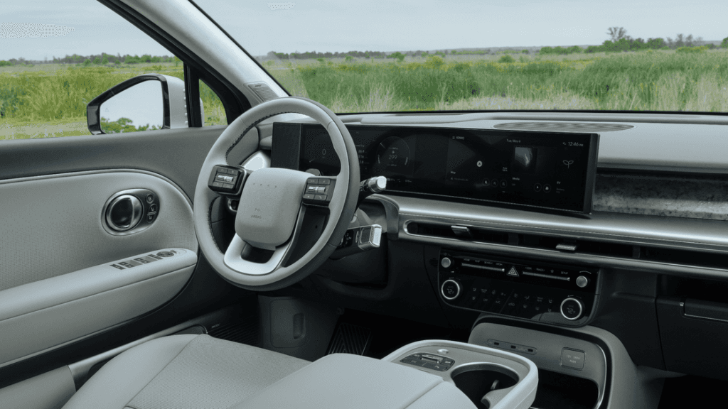 2026 Hyundai IONIQ 9 interior close-up of steering wheel, digital cluster, and widescreen display.