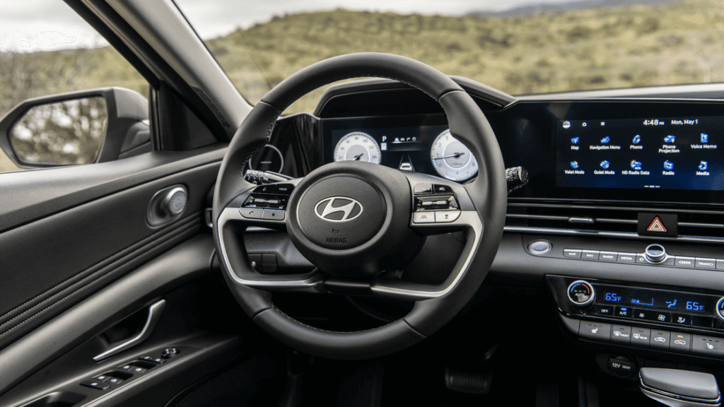 2025 Hyundai Elantra interior view showing steering wheel, touchscreen display, and dashboard.