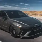 2026 Hyundai Elantra N sports sedan in black driving fast on desert highway with dynamic styling.