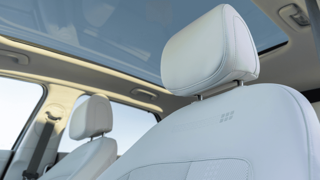 2026 Hyundai IONIQ 5 close-up of white leather seat and panoramic sunroof view.