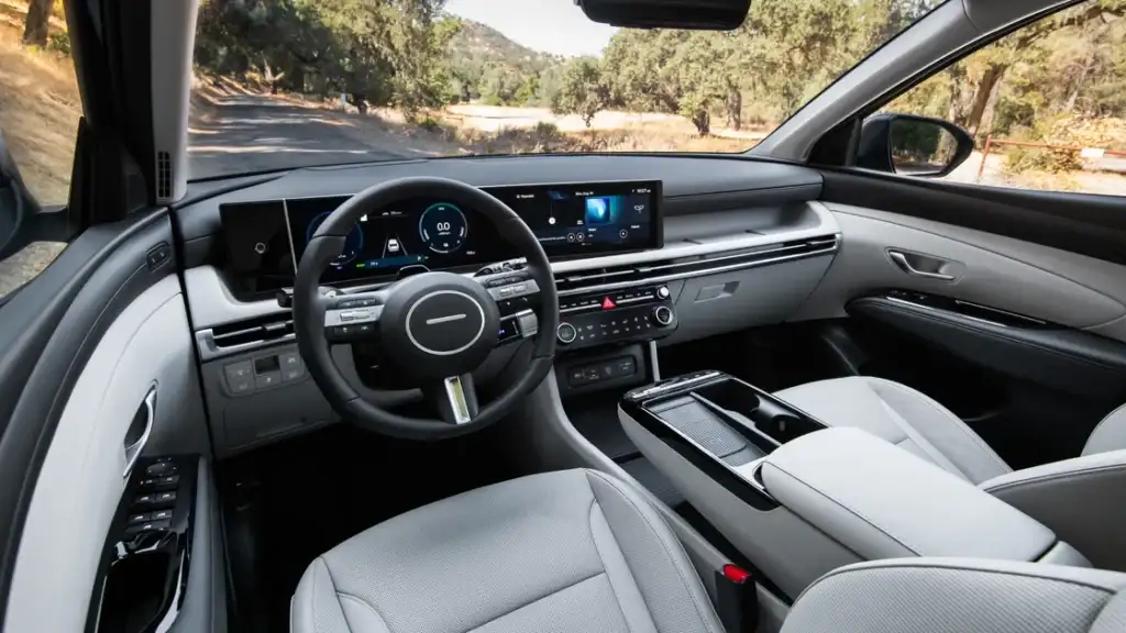 Interior front cabin of the 2025 Hyundai Tucson showing digital cockpit and premium materials.