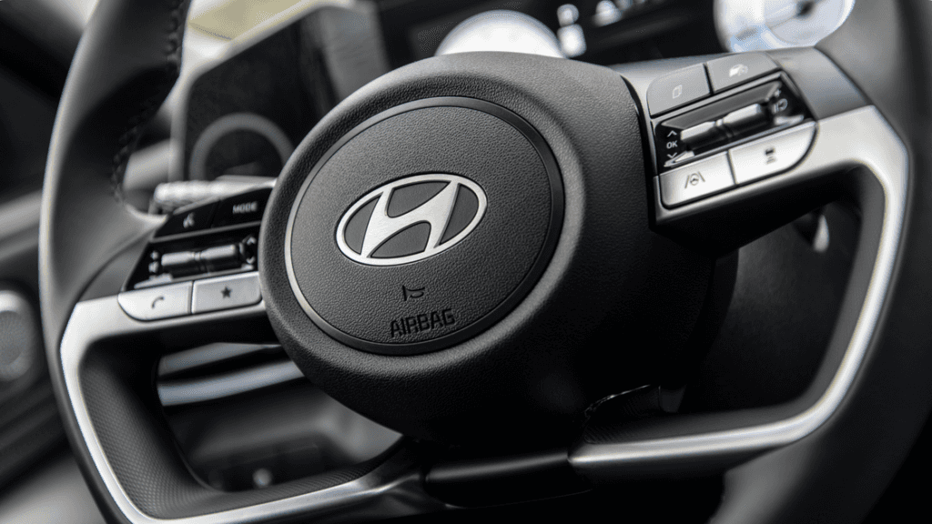 2025 Hyundai Elantra steering wheel close-up showing Hyundai logo and control buttons.