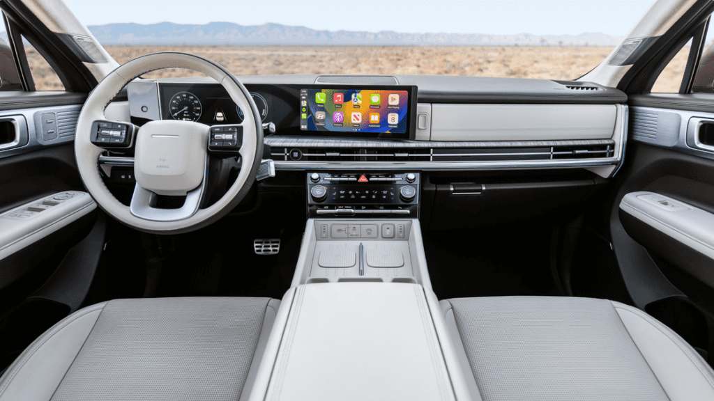 2025 Hyundai Santa Fe Hybrid front cabin with widescreen displays and modern dashboard.