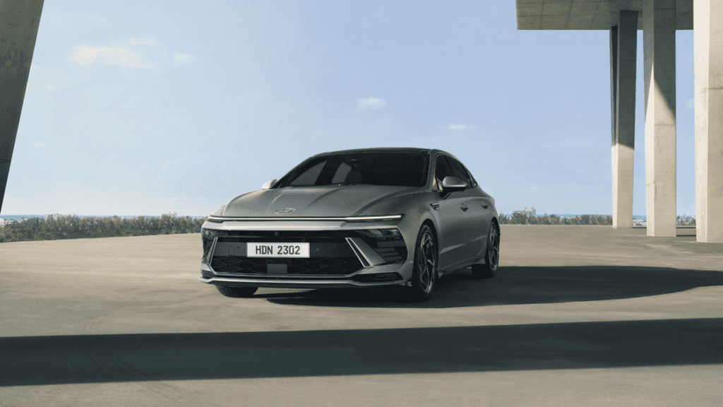 2025 Hyundai Sonata front angle view in open space featuring aggressive grille and slim LEDs.