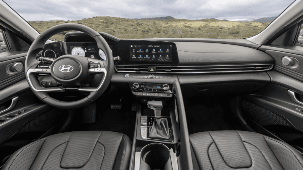 2026 Hyundai Elantra interior with panoramic dashboard, digital displays, and light gray seating.