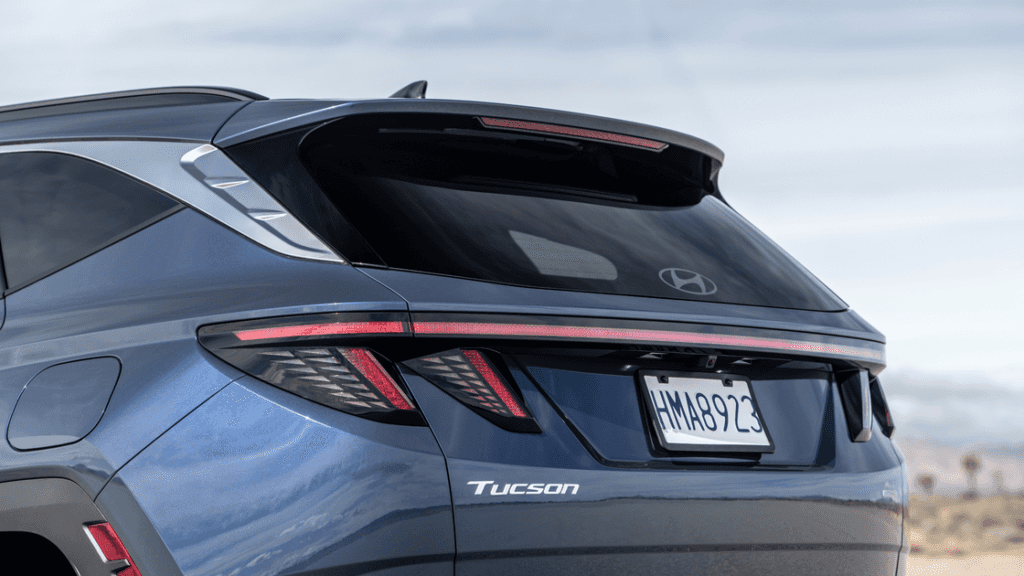 2026 Hyundai Tucson rear exterior showing LED taillights, sculpted tailgate, and Tucson badging.