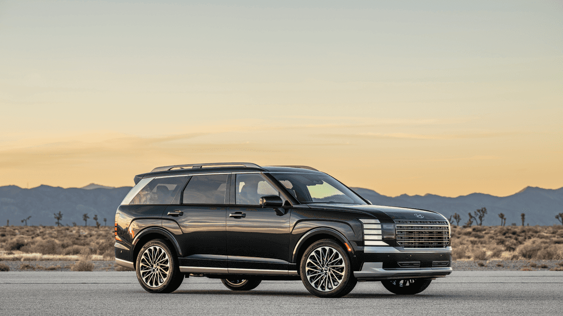 2026 Hyundai Palisade full size SUV side profile in black parked on open road at sunset.