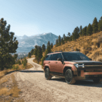 2026 Hyundai Santa Fe Hybrid SUV front three quarter view on mountain dirt road.