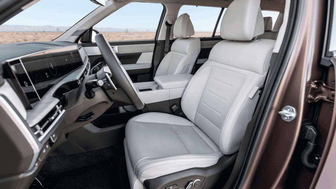 Interior seating view of the 2026 Hyundai Santa Fe Hybrid highlighting light upholstery, wide cabin space, and premium comfort features.