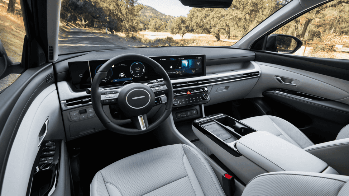 Interior dashboard view of the 2026 Hyundai Tucson Hybrid featuring digital instrument cluster, infotainment screen, and clean cockpit design.