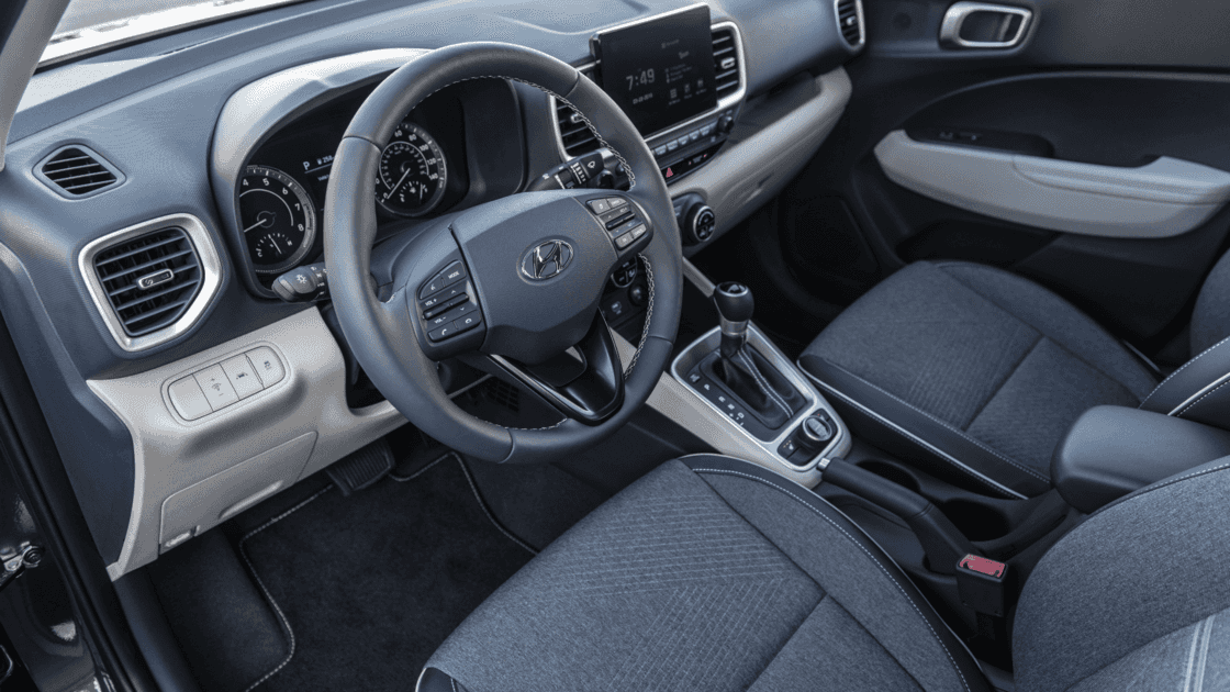 Interior cockpit view of the 2026 Hyundai Venue showing steering wheel controls, infotainment display, and compact SUV dashboard.