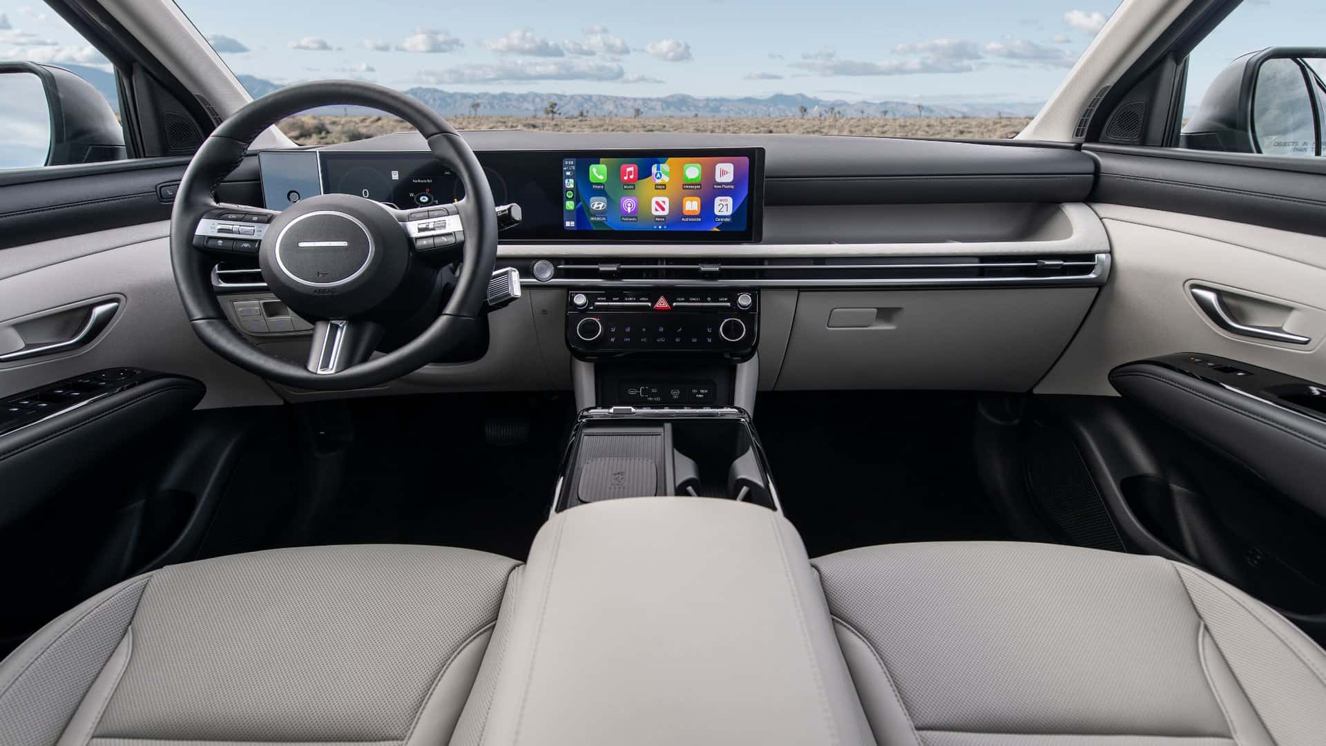 2026 Hyundai Tucson interior dashboard featuring panoramic digital displays, push-button controls, and refined two-tone cabin design.