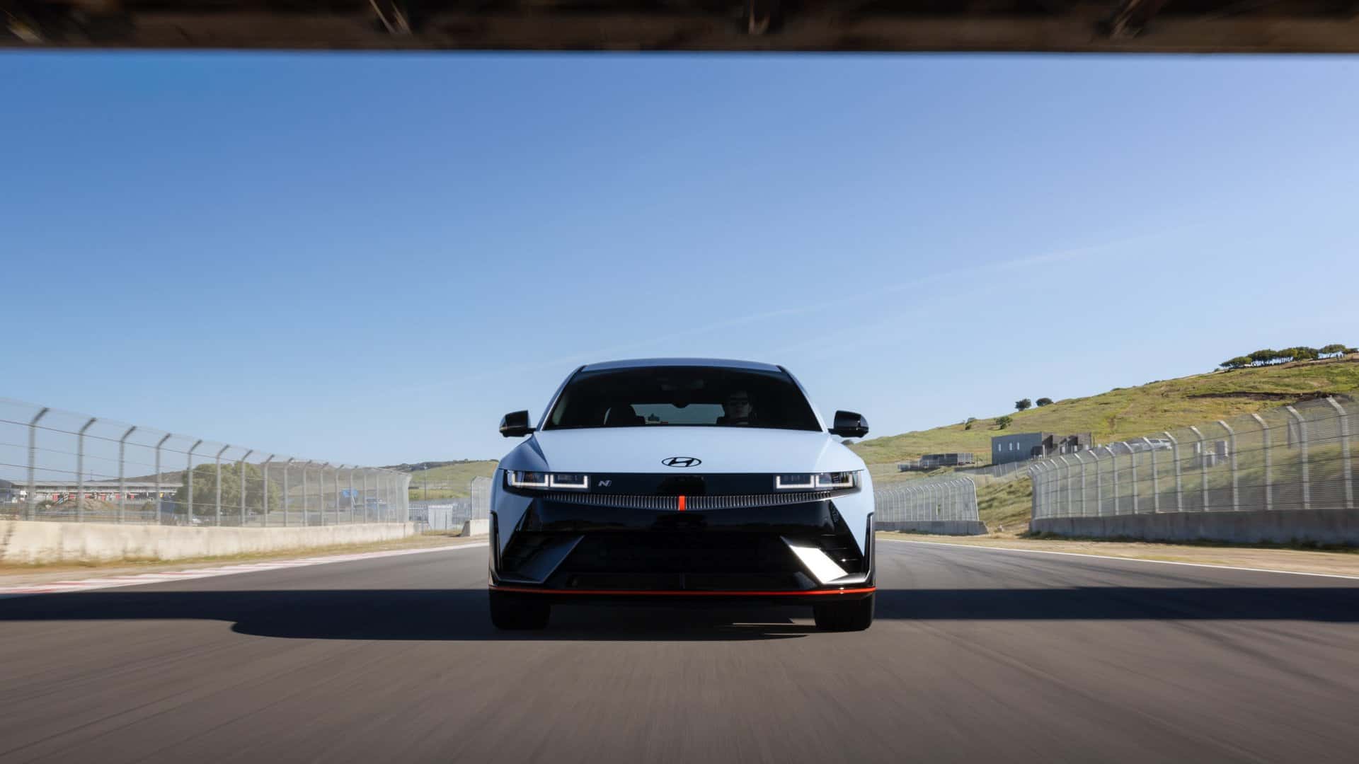 2026 Hyundai IONIQ 5 N front view driving on a racetrack showing performance electric hatchback design.