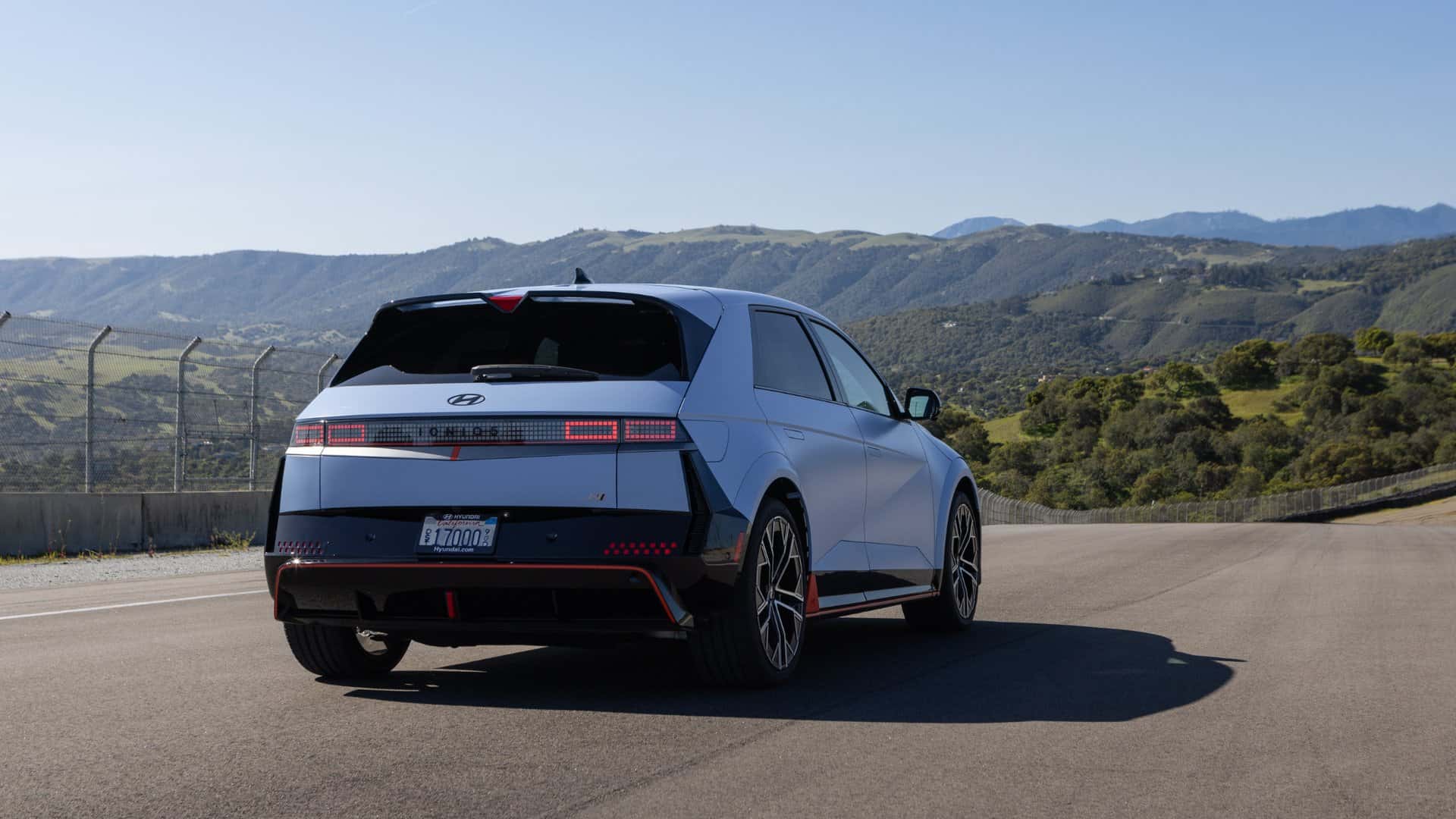 2026 Hyundai IONIQ 5 N rear exterior driving on track highlighting aerodynamic styling and LED tail lights.