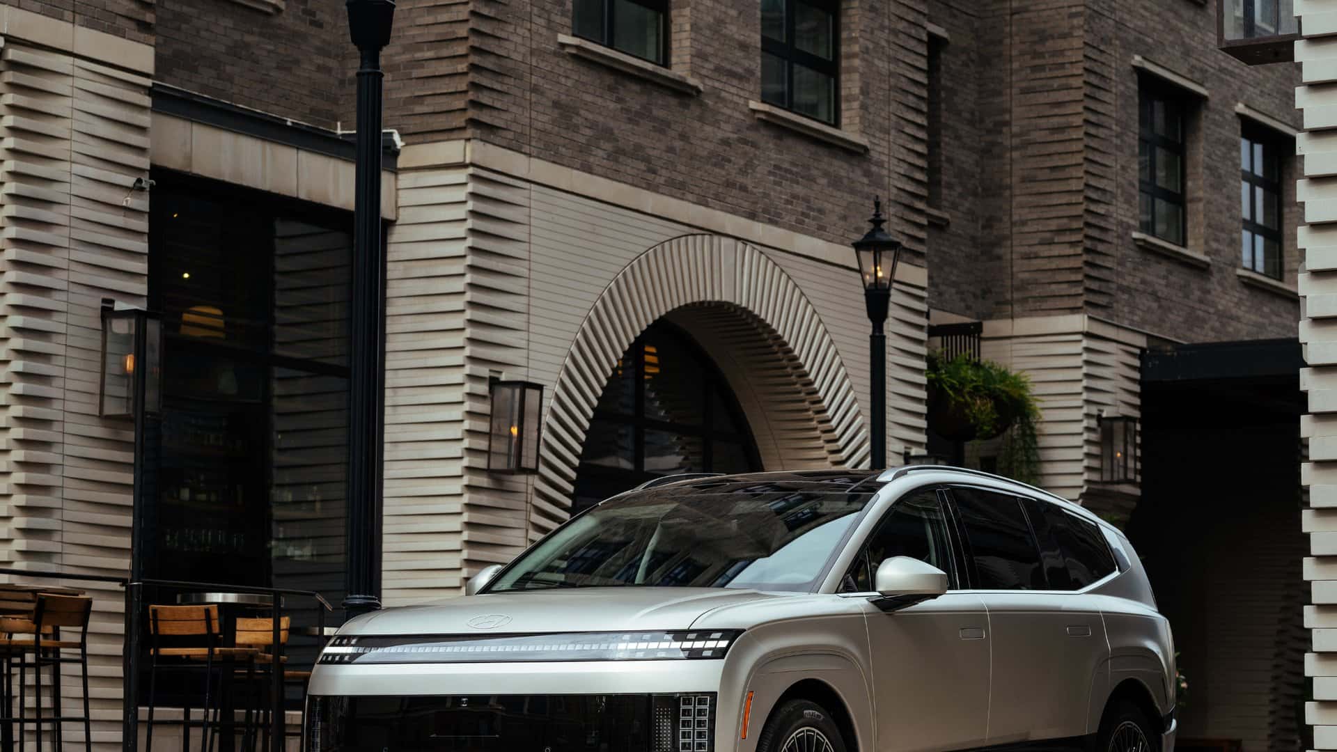 2026 Hyundai IONIQ 9 luxury electric SUV side profile parked near park landscape.