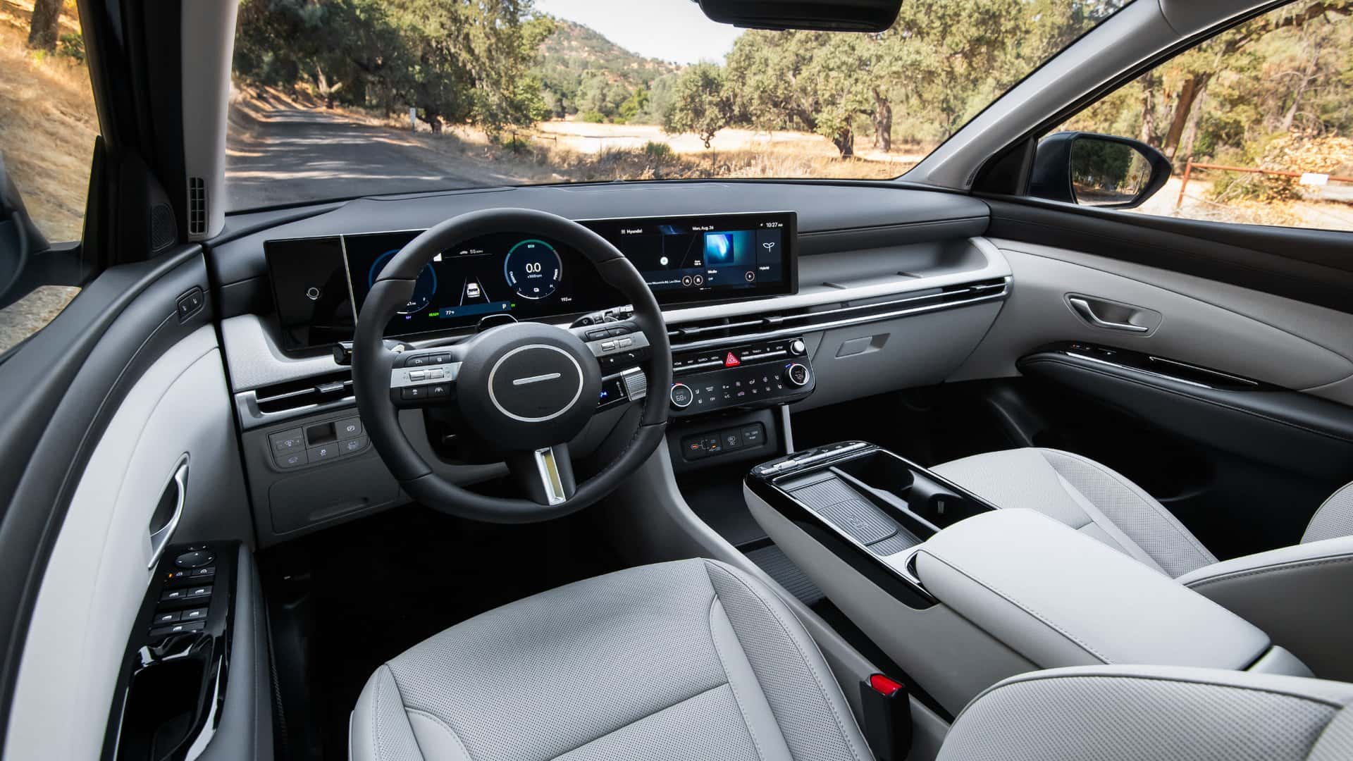 2026 Hyundai Tucson Hybrid interior dashboard with digital cluster and center touchscreen.