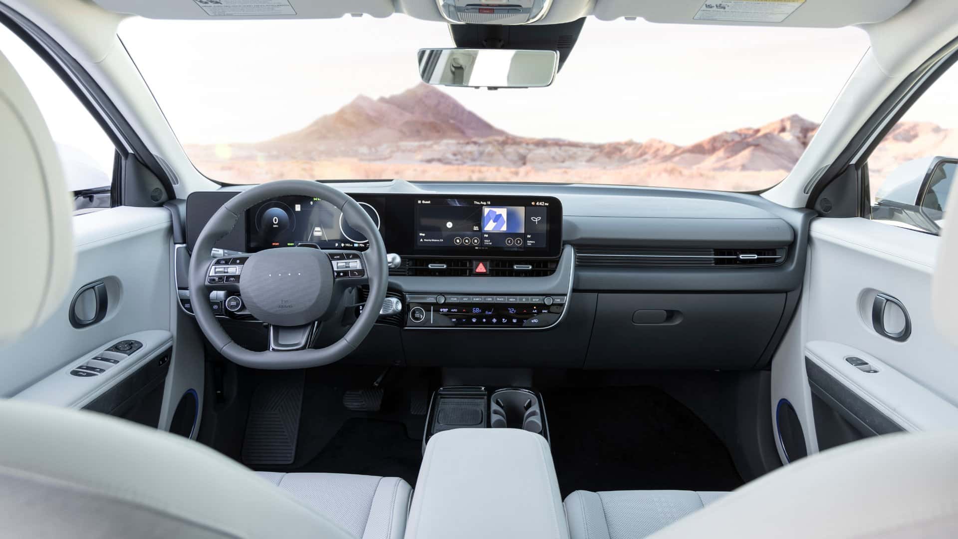 2026 Hyundai IONIQ 5 interior dashboard with dual screens steering wheel and minimalist cabin design.
