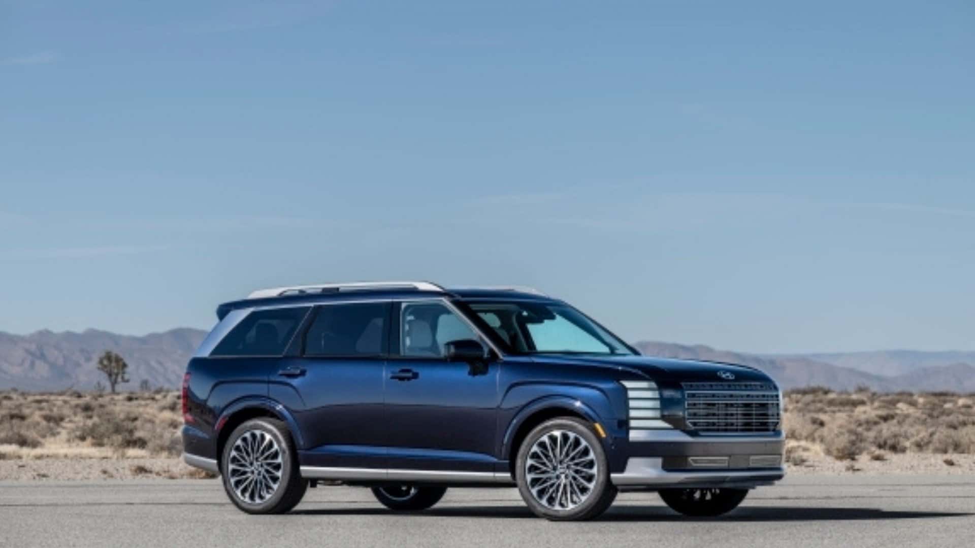 2026 Hyundai Palisade SUV parked in side profile with dark exterior and large alloy wheels.