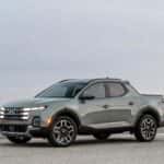 2026 Hyundai Santa Cruz pickup parked in front three quarter view on an open desert road.