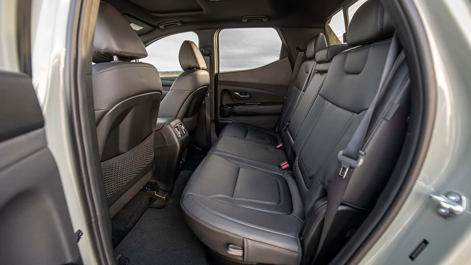 2026 Hyundai Santa Cruz rear seat interior with black upholstery and second row passenger space.