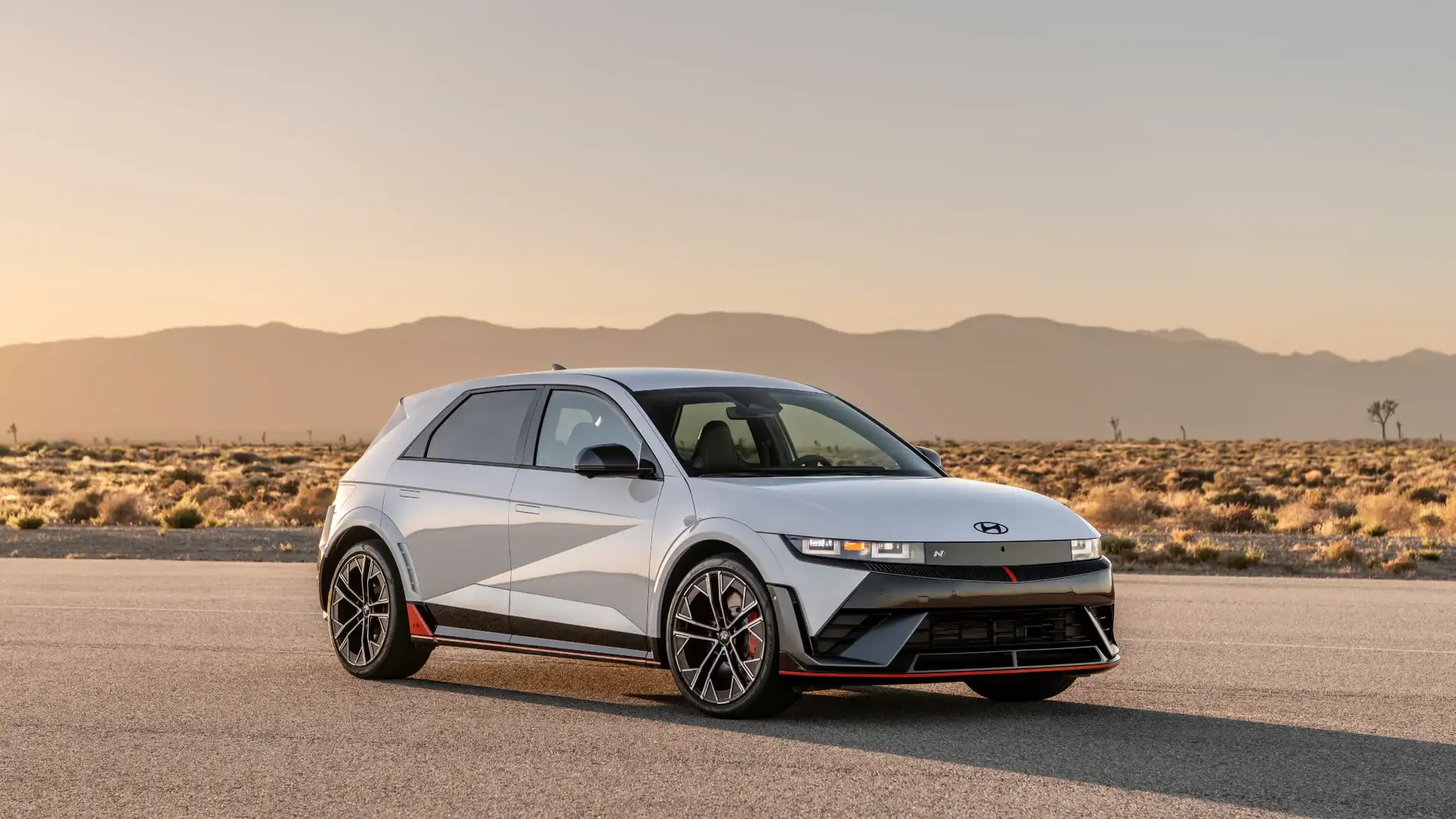 2026 Hyundai IONIQ 5 N white electric SUV parked in desert landscape with sport wheels and red trim.
