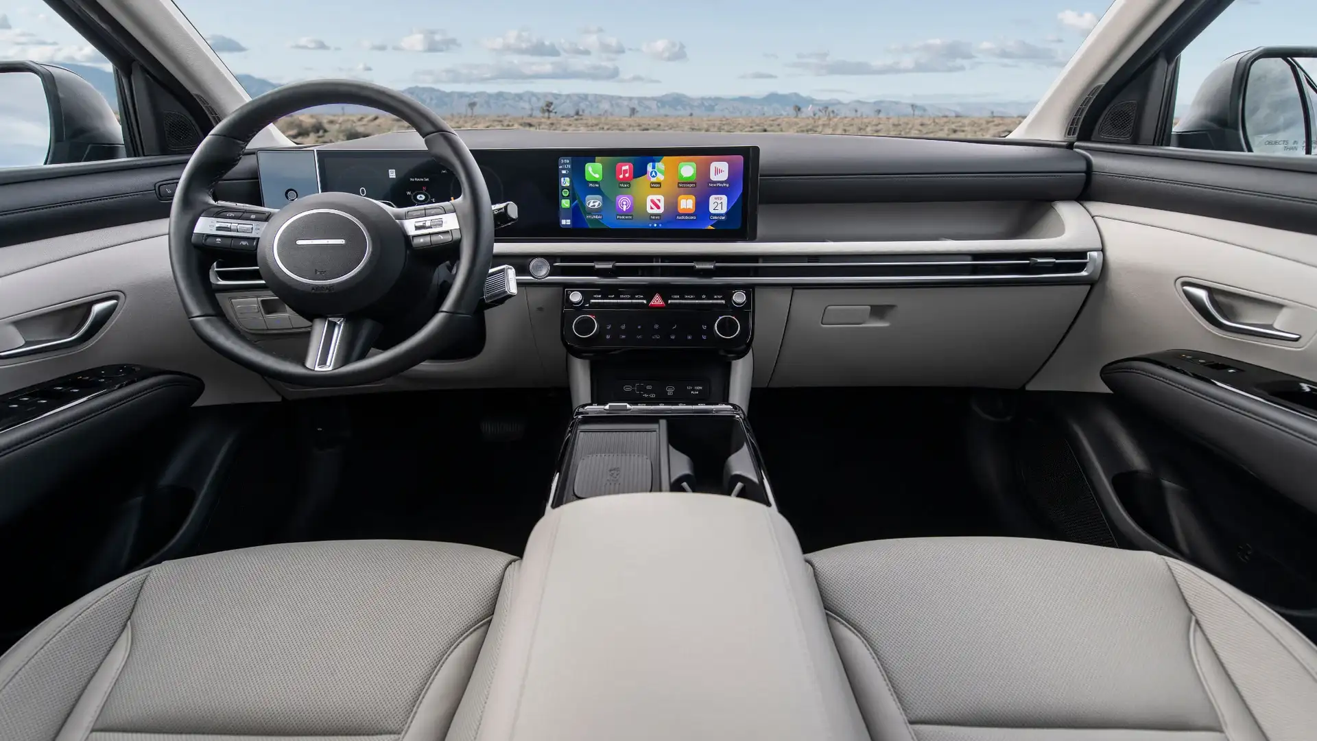 2026 Hyundai Tucson interior dashboard with touchscreen, Apple CarPlay display, and light cabin trim.