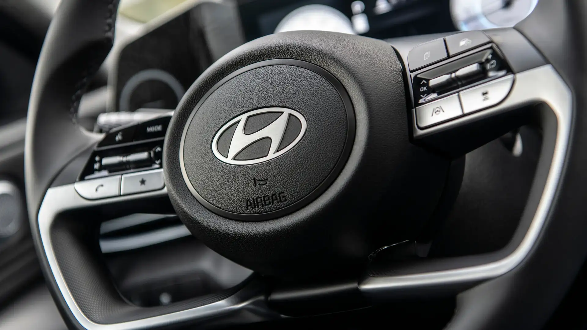 2026 Hyundai Elantra steering wheel close-up with Hyundai badge and driver assistance controls.