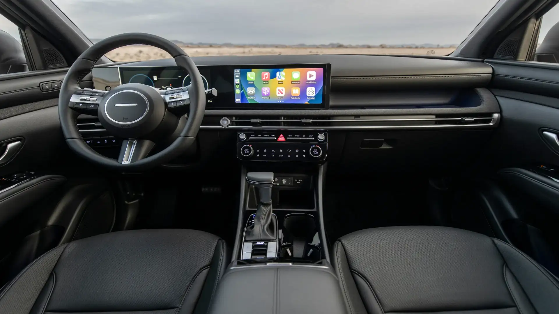 2026 Hyundai Santa Cruz interior with touchscreen display, steering wheel, and black dashboard.