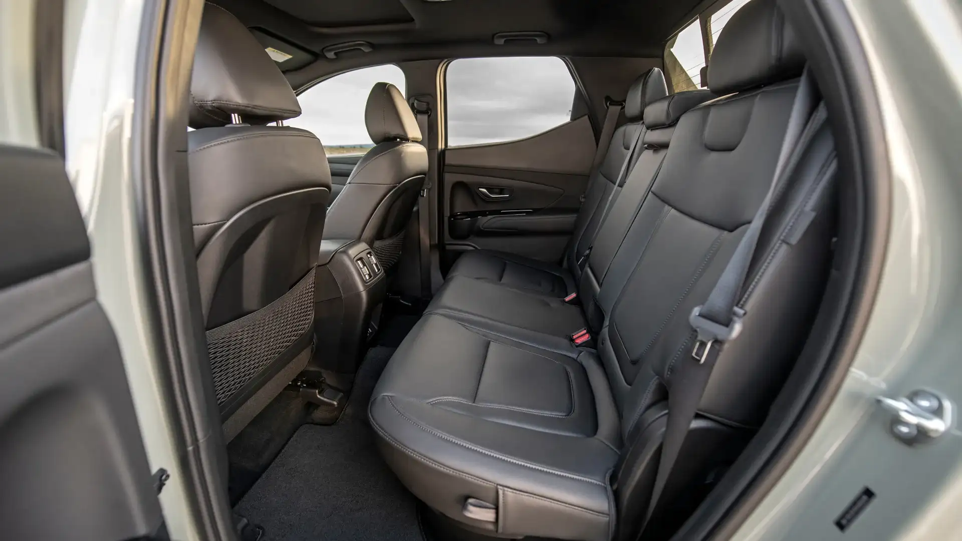 2026 Hyundai Santa Cruz rear bench seat with black leather upholstery and door panel detail.