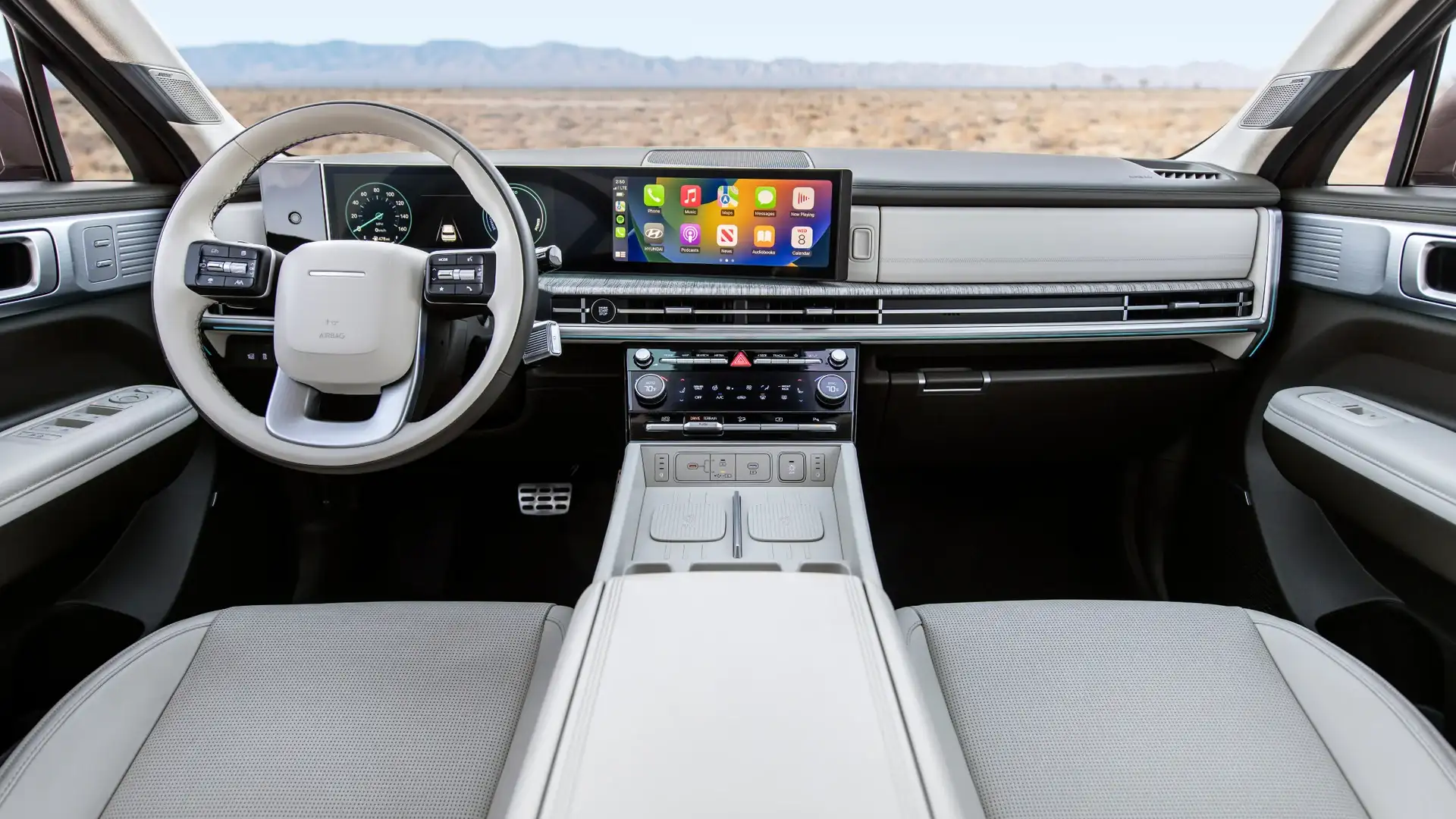 2026 Hyundai Santa Fe Hybrid dashboard with wide touchscreen, light trim, and Apple CarPlay display.