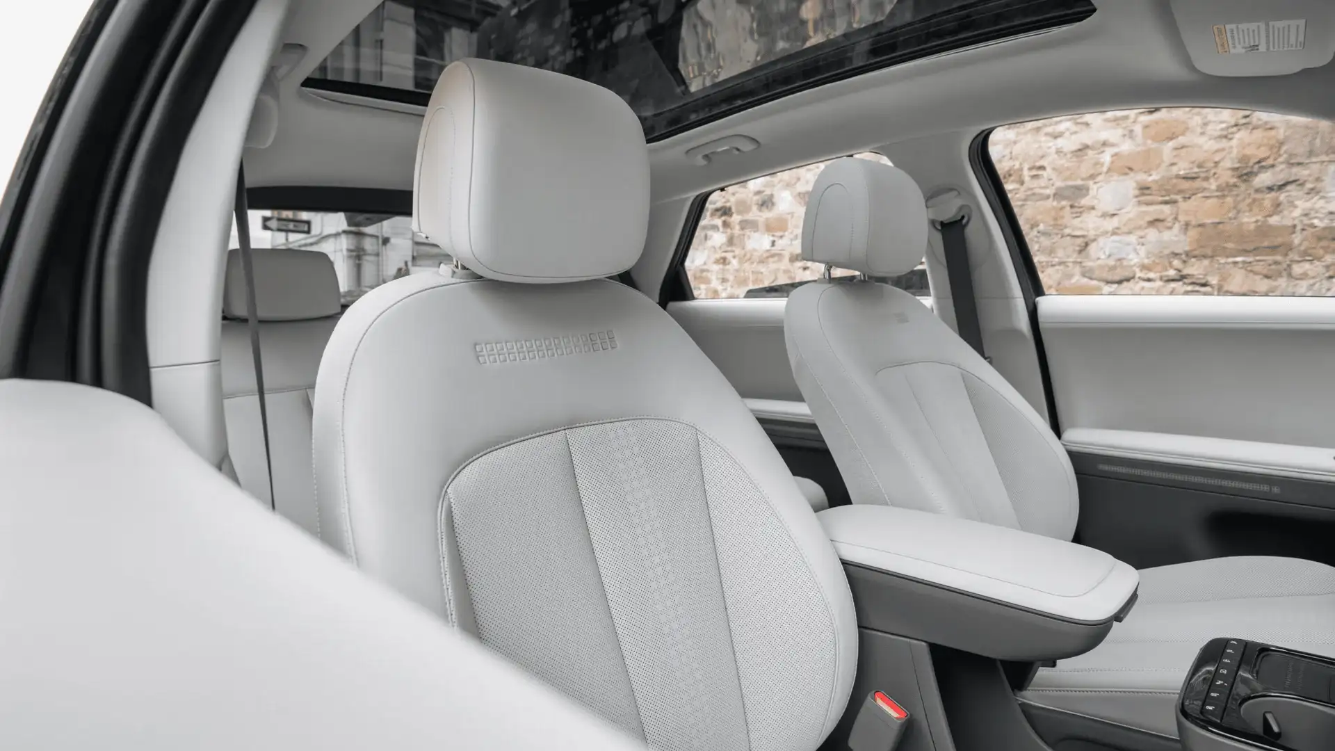 2026 Hyundai IONIQ 5 front seats with light upholstery, panoramic roof, and clean cabin design.
