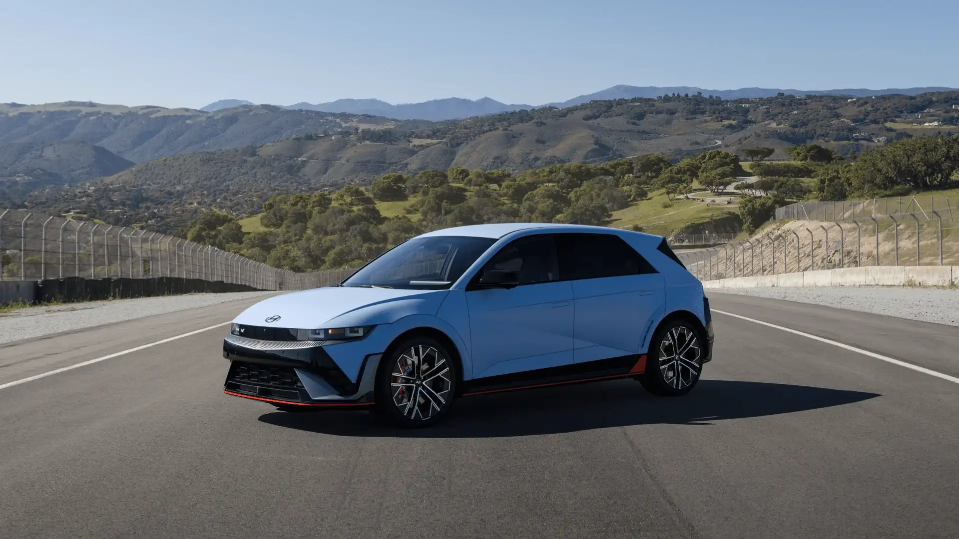 2026 Hyundai IONIQ 5 N blue electric SUV parked on track with mountain backdrop.