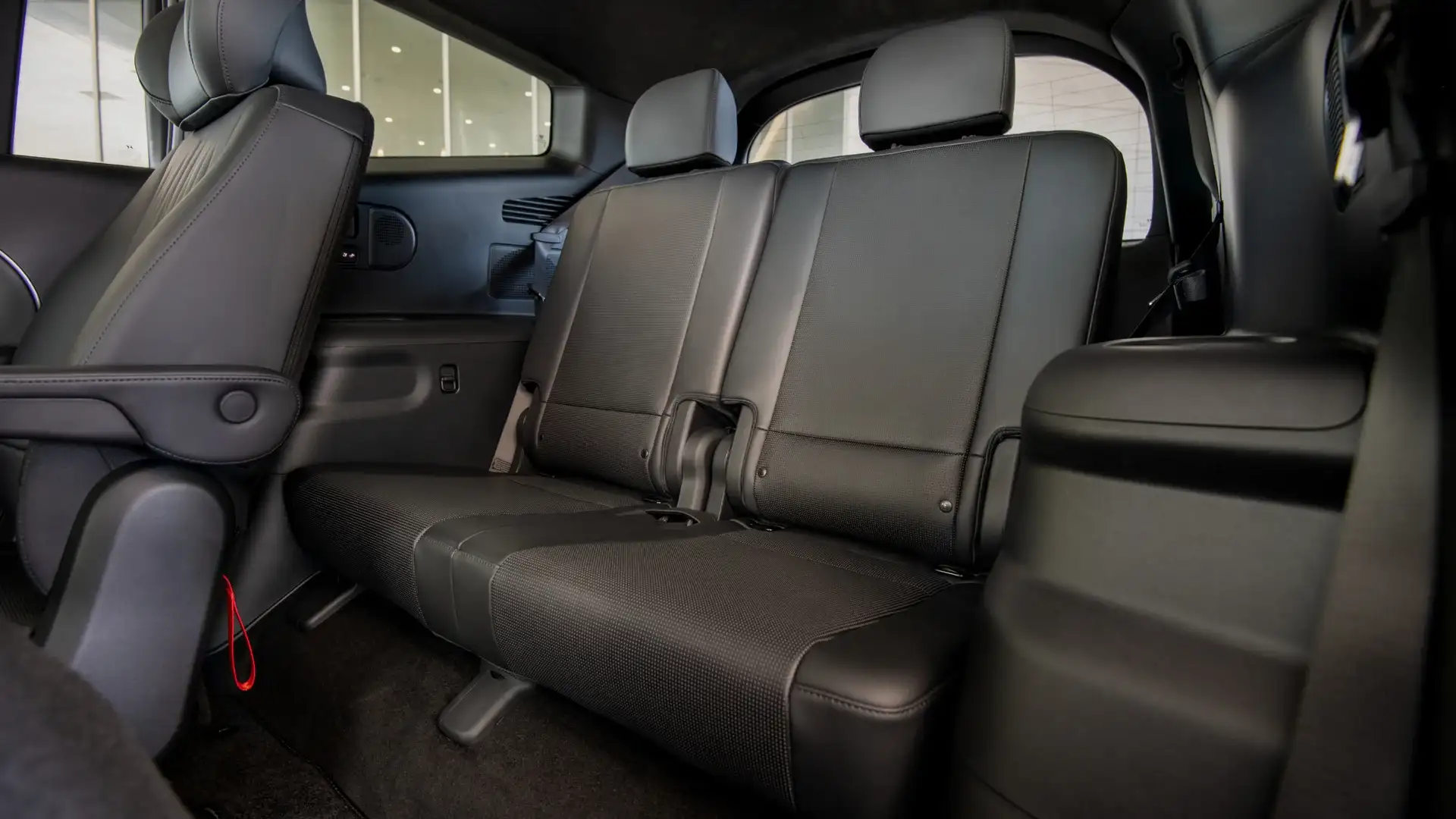 2027 Hyundai IONIQ 9 second-row interior with light gray captain’s chairs and open cabin space.