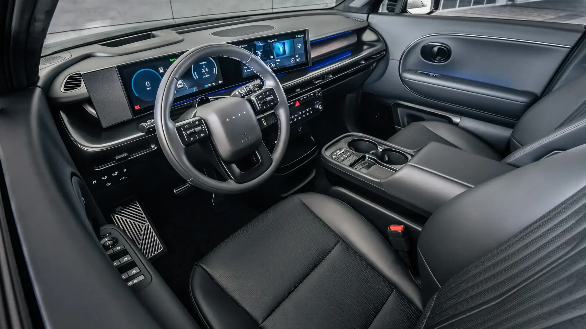 2027 Hyundai IONIQ 9 interior with light gray dashboard, digital screens, and coastal view.
