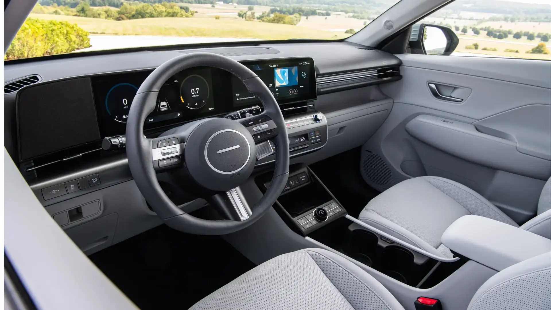 2027 Hyundai Kona interior with light gray seats, digital dashboard, and center console.