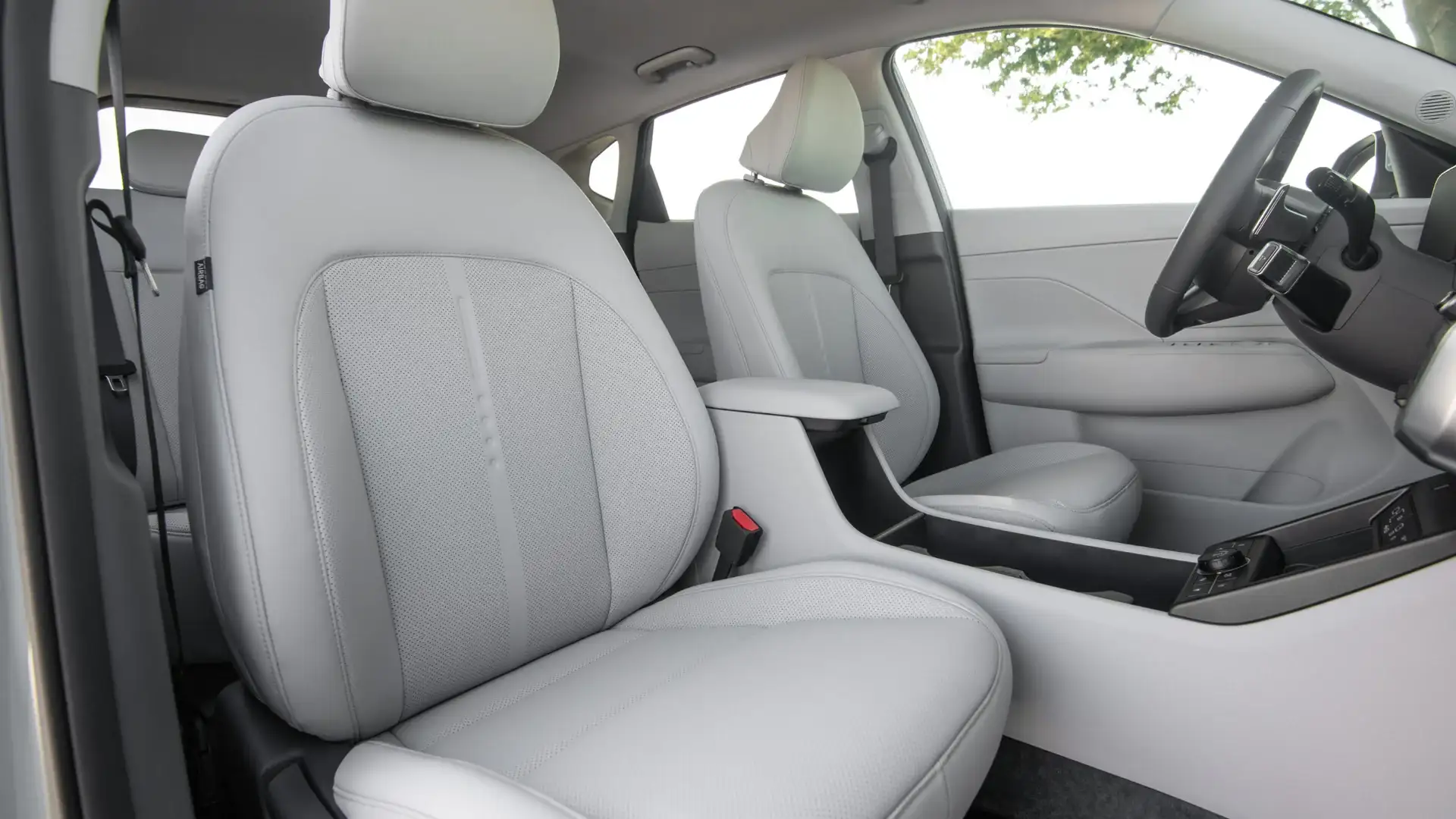 2027 Hyundai Kona front cabin with light gray seats, armrest, and modern interior trim.