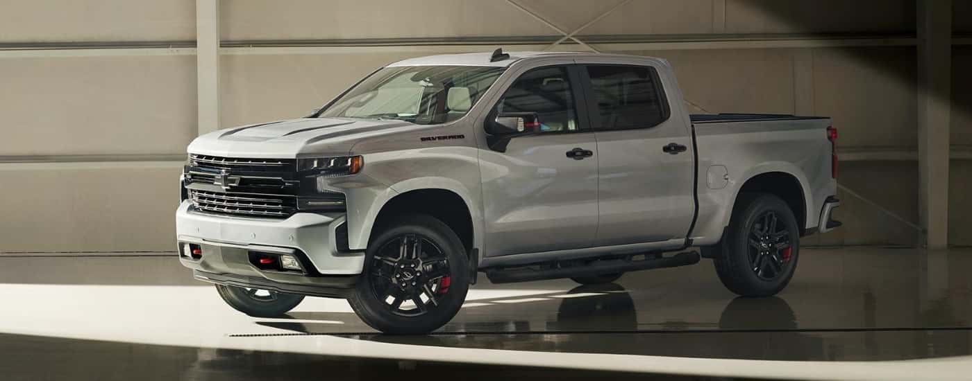 A silver 2020 Chevy Silverado 1500 Redline is shown in a warehouse.