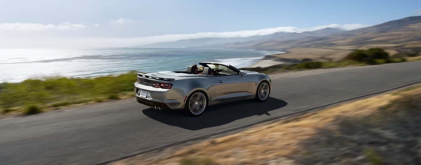 A silver 2024 Chevy Camaro 3LT is shown driving to a Chevy dealer near Kingston.
