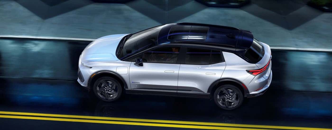 High angle view of a white 2024 Chevy Equinox EV 3RS driving through a tunnel.