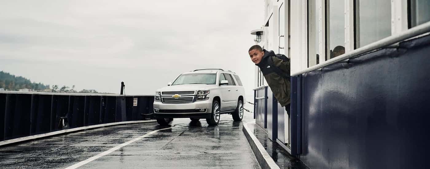 A silver 2020 Chevy Tahoe is parked on a ferry.