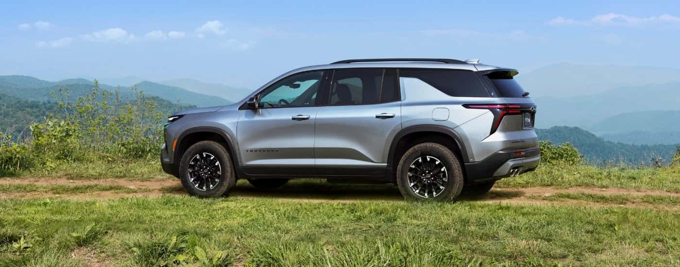 A silver 2024 Chevy Traverse Z71 is parked on grass.