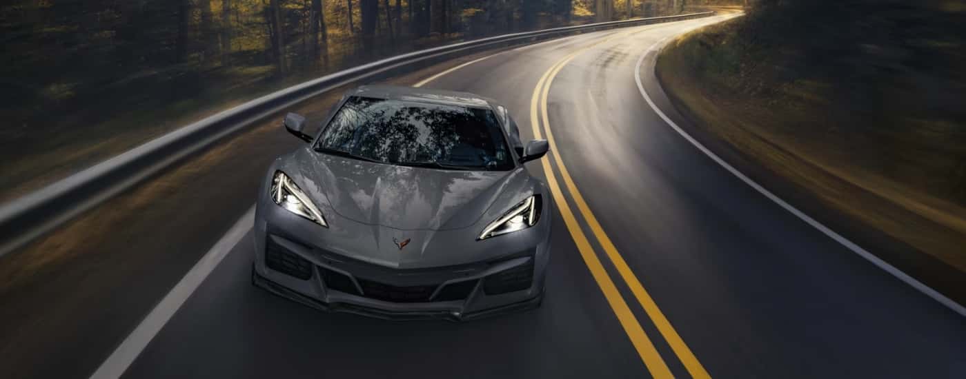 A grey 2025 Chevy Corvette E-Ray is driving to a Chevy dealer near Plaistow.
