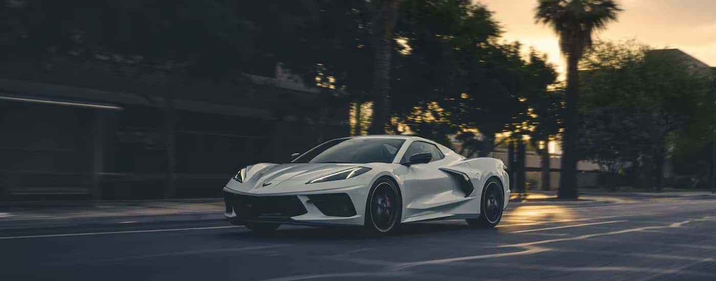White 2025 Chevy Corvette Stingray driving down the street