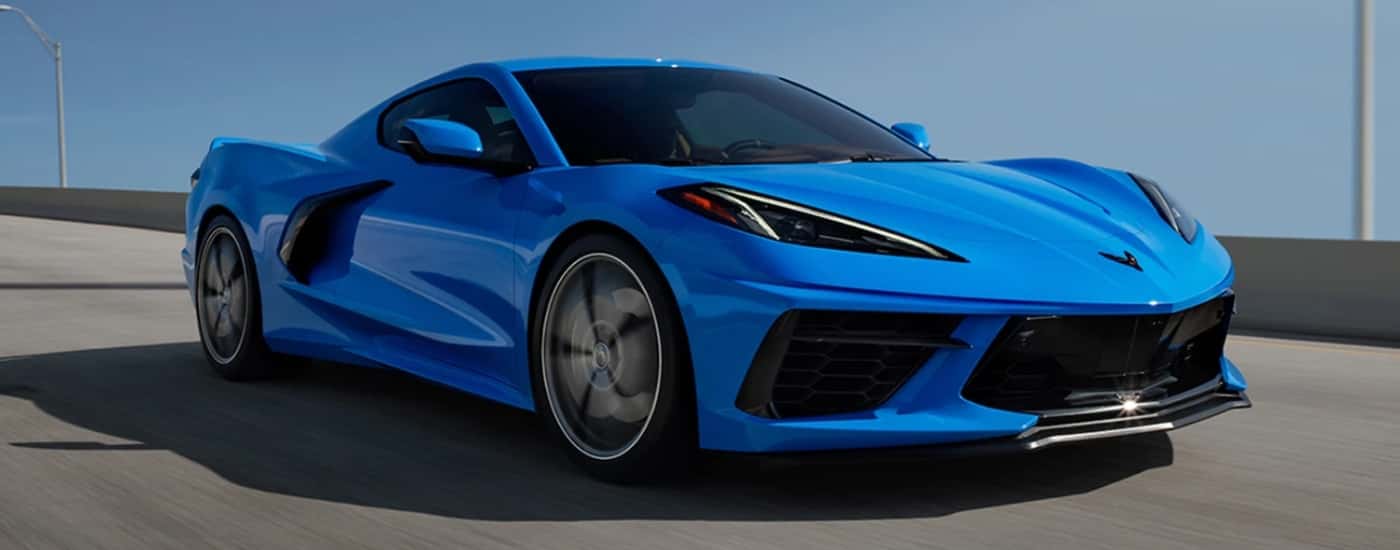 A blue 2024 Chevy Corvette Stingray 3LT Z51 driving over a bridge.