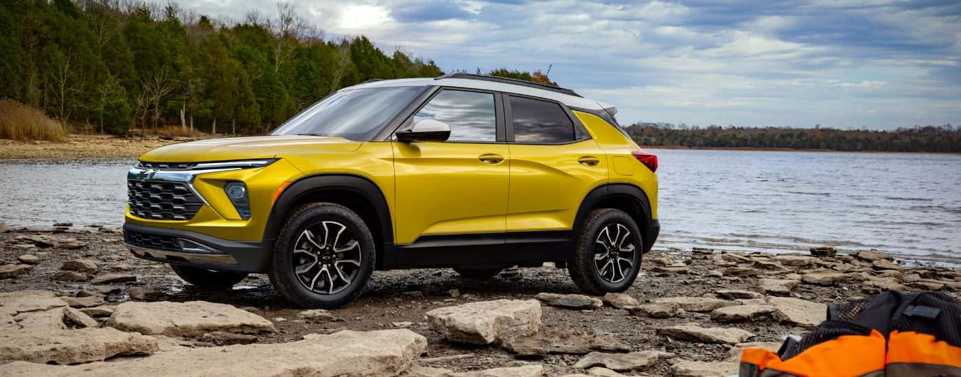 A yellow 2024 Chevy Trailblazer ACTIV is shown near a lake after leaving a Chevy dealer near Manchester.