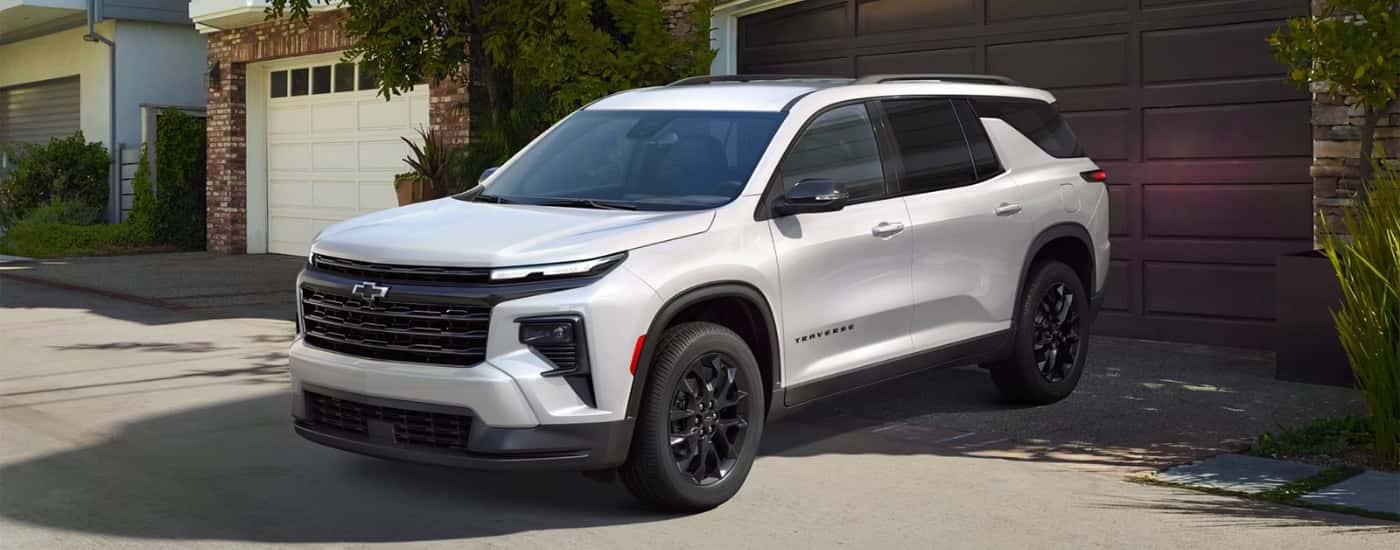 A white 2025 Chevy Traverse High Country is shown parked after visiting a Chevy dealer near Rye.