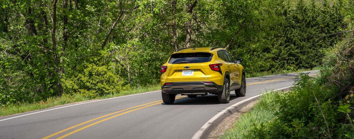 A yellow 2025 Chevy Trax for sale near Newton from the rear at an angle.